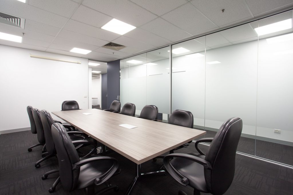 Image of boardroom table and chairs in a conference room